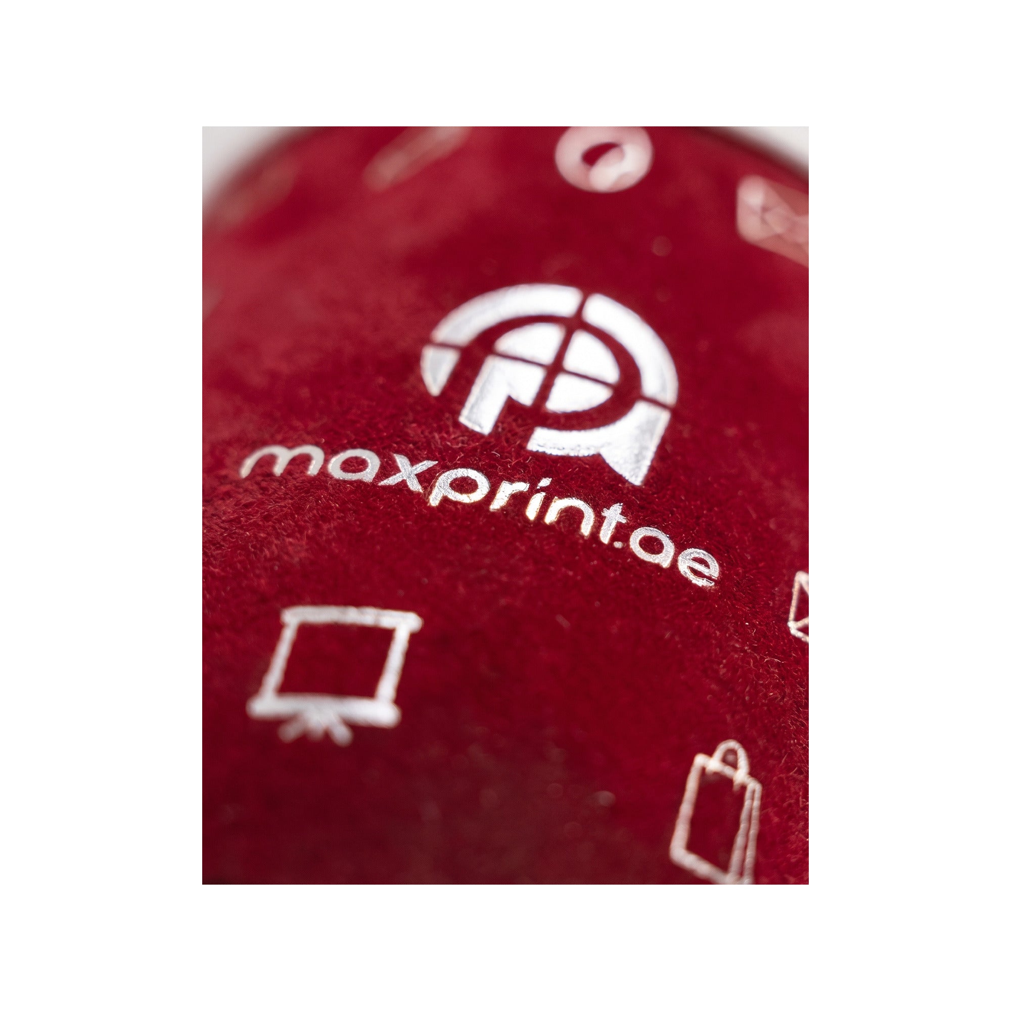 Close-up of silver foil stamped on red velvet paper cup — MaxPrint Dubai